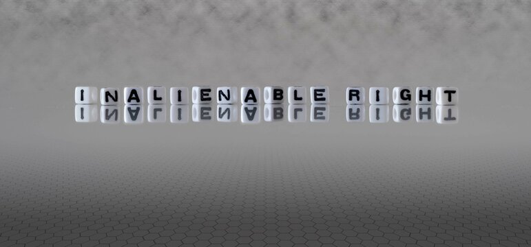 inalienable right word or concept represented by black and white letter cubes on a grey horizon background stretching to infinity