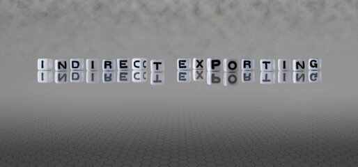 indirect exporting word or concept represented by black and white letter cubes on a grey horizon...