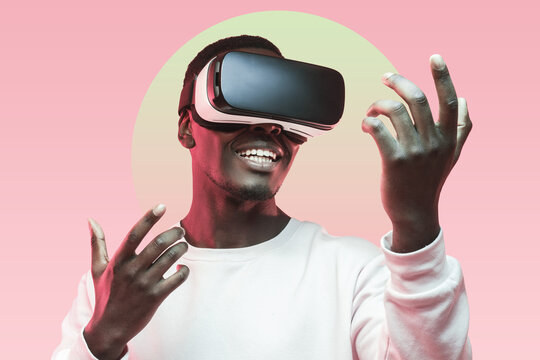 Smiling african man using virtual reality headset for playing games