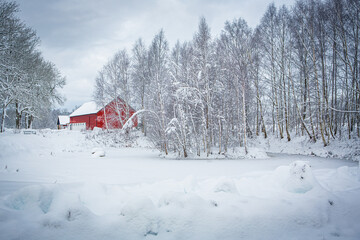 Red house in Swedish winter landscape