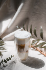 Close-up glass of iced coffee with milk on the table