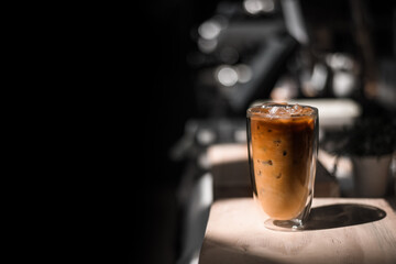 Close-up glass of iced coffee with milk on the table