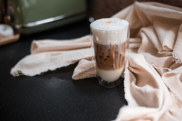Close-up glass of iced coffee with milk on the table