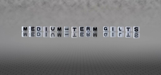 medium term gilts word or concept represented by black and white letter cubes on a grey horizon background stretching to infinity