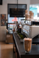 Close-up glass of iced coffee with milk on the table