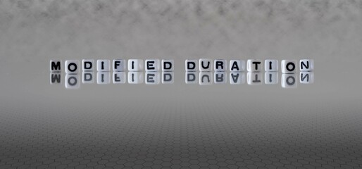 modified duration word or concept represented by black and white letter cubes on a grey horizon...
