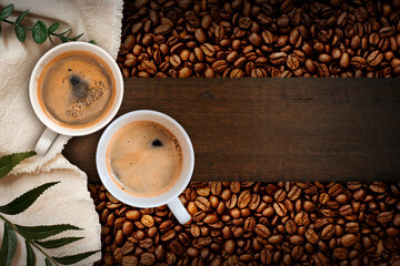 Cup of coffee with coffee beans on table