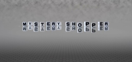 mystery shopper word or concept represented by black and white letter cubes on a grey horizon...