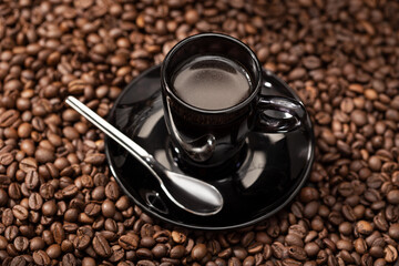 Espresso Coffee in black cup and roasted beans