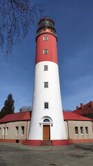 Operating red - white lighthouse in the city of Baltiysk, Kaliningrad region.