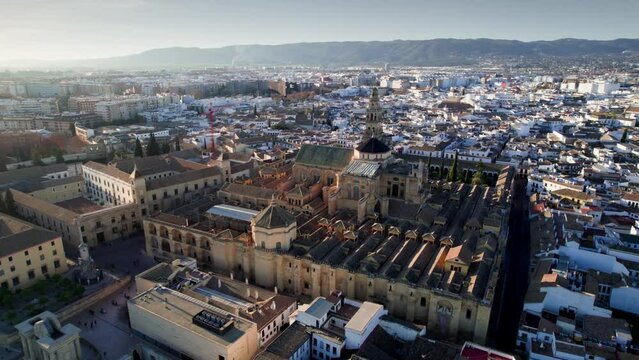 Flying above historic town of Cordoba, Spain. Drone flight around Mosque cathedral in Cordoba, tourism in Andalusia, unesco site.