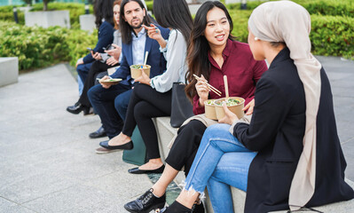 Fototapeta premium Multiethnic business people doing lunch break outdoor from office building - Meeting and entrepreneur concept