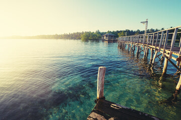 Beautiful landscape. Sunset on the seashore. Wooden bridge on the beach, Siargao Island, Philippines.