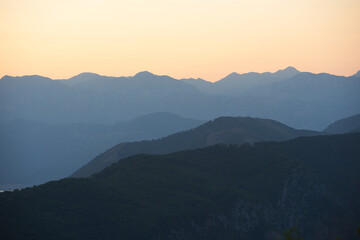 Sunset mountain range silhouette in golden hour