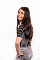 Portrait of beautiful smiling girl with long hair. The young woman is wearing jeans and a striped t-shirt.