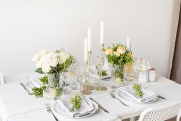 The wedding decor. Wedding teble decoration with white roses