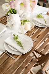 The wedding table setting and decor on wooden table in rustic style