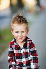 Portrait of a cute blonde european boy, outdoor