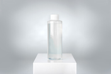 clean bottle of micellar water on white pedestal