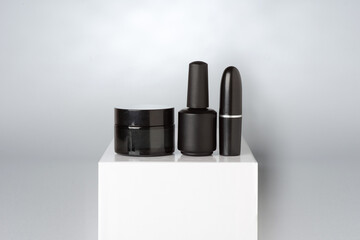 Mockup with clean set of black cosmetics on a pedestal