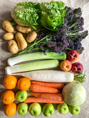 Healthy eating: grocery shopping or delivery of fresh fruits and vegetables. Rich vitamin vegetables. Variety of fruits and vegetables on craft paper. Fresh potatoes lettuce purple sprout broccoli lee