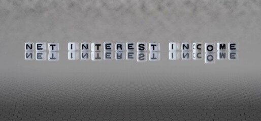net interest income word or concept represented by black and white letter cubes on a grey horizon...