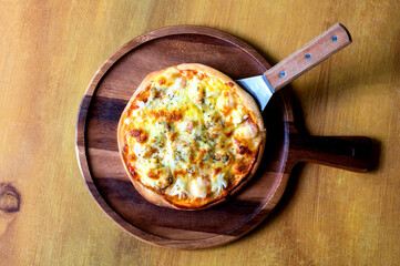 Delicious seafood pizza on vintage wooden table, top view. Space for text