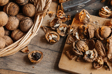 Walnuts close up stuffed on a stand and illuminated by warm light on a wooden background.