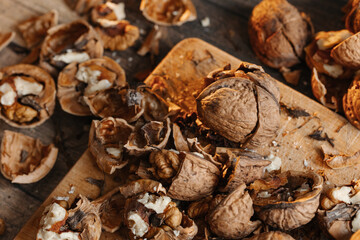 Walnuts close up stuffed on a stand and illuminated by warm light on a wooden background.