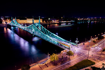 Budapest, Liberty Bridge in night with yellow tram, aerial view