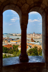 Coast with parliament in budapest, view through the window of a fishing bastion