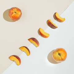 Fototapeta na wymiar Fresh orange-yellow peaches on the nude and white background. Juicy peach slices flat lay. Summer idea.