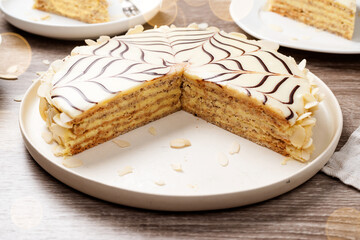 Esterhazy- traditional cake with almonds and pralines on a wooden background . Hungarian, Austrian dessert.