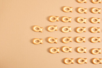 pattern of cookies in the shape of a fish on a beige background