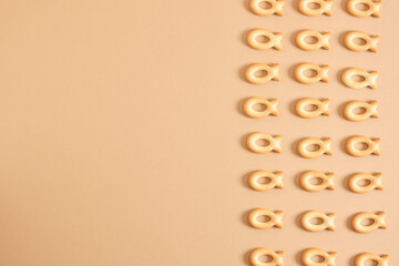 pattern of cookies in the shape of a fish on a beige background