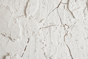 Cracking ground texture. white texture with cracks and potholes