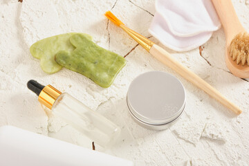 dry and tired skin care set on cracked white natural background