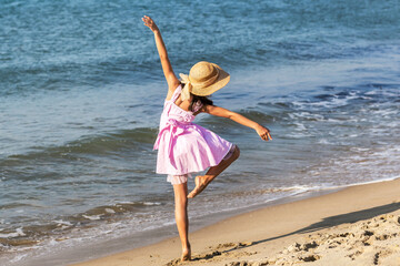 Beach Dancer Girl. Ballerina by the Sea. Attractive ballerina practices on sandy coastline....
