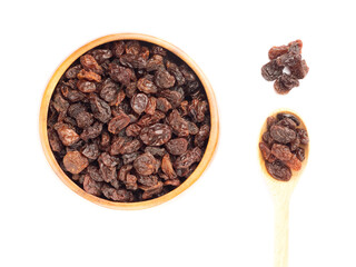 Raisin in brown wooden bowl, spoon, bunch, isolated on white background