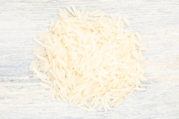 Bunch of Long Basmati rice on white wooden background. Macro. Flat lay. Healthy food concept