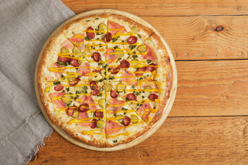 pizza on a tray on a wooden background close up