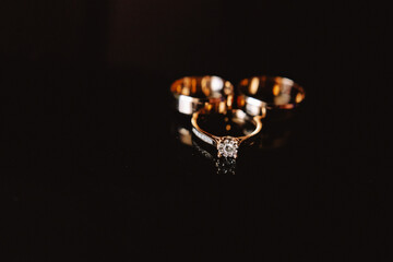 Diamond rings on black Chic wedding rings with diamonds on a black background with a light color...