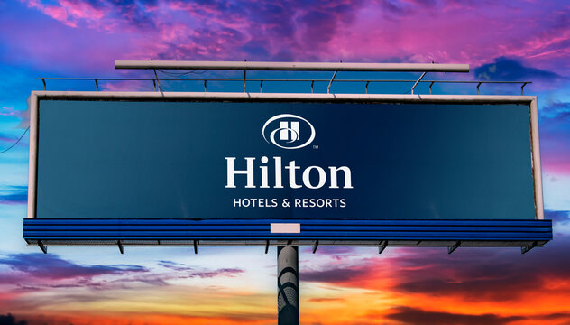 Billboard displaying logo of Hilton Hotels and Resorts