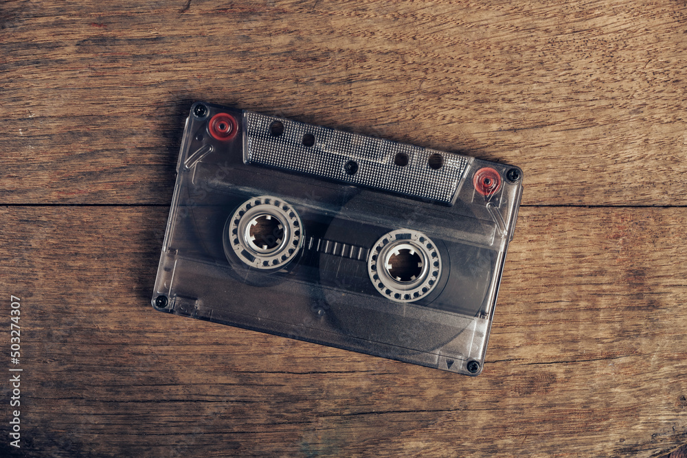Poster beautiful audio cassette tape on a brown old wooden table. minimalism retro style concept. 80s. back