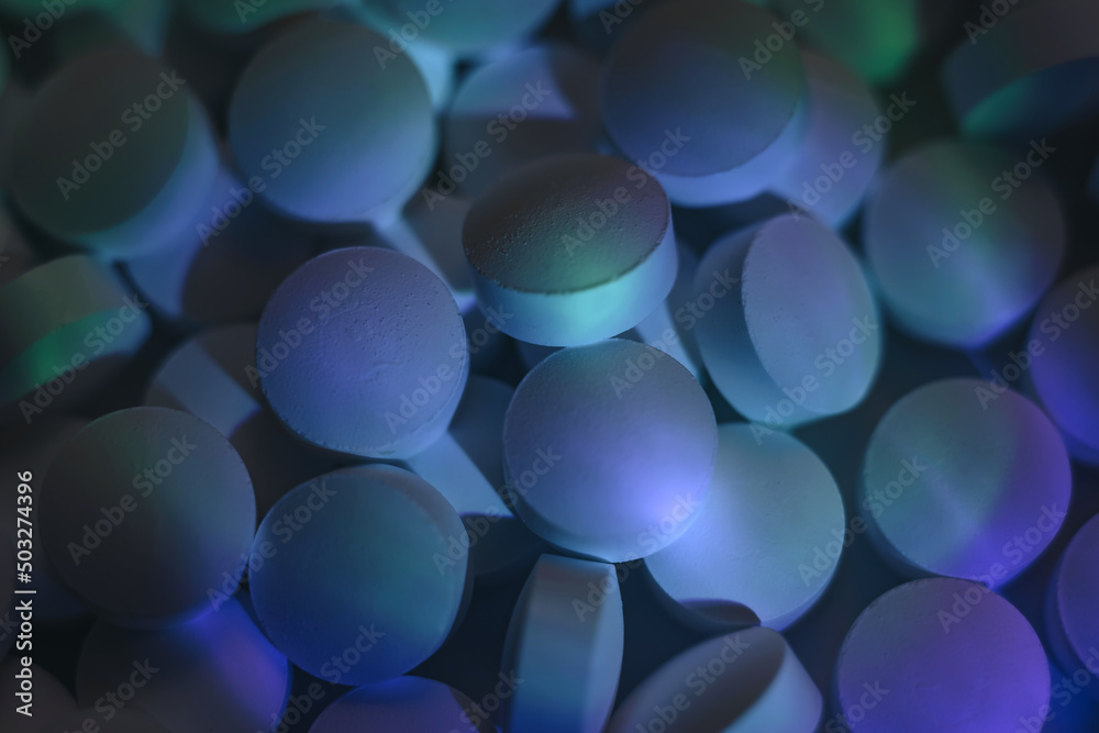 Poster pills or drugs in a package under neon light. beautiful background pattern for design.