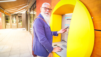 Senior man with ATM