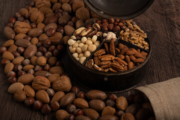 Mixed nuts on a dark wood background