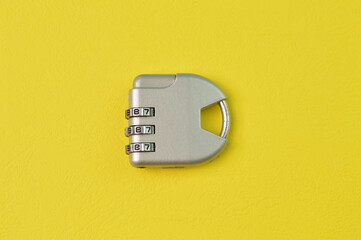 Steel padlock isolated on a yellow background