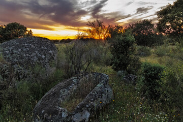 Landscape at sunset in the Barruecos Natural Area. Spain. In the foreground there is an anthropomorphic tomb of several that exist in this area. 