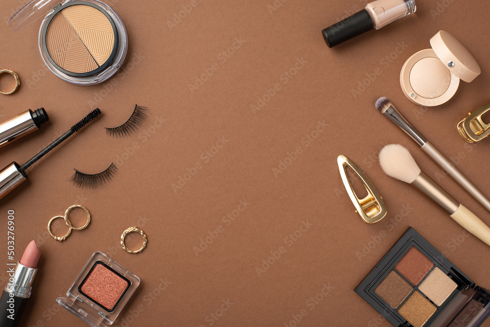 Wall mural makeup concept. top view photo of contouring and eyeshadow palettes false eyelashes mascara gold rin